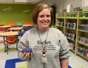 Elemetary Teacher Ashley Bushong with a musical instrument she purchased through a mini grant from the Alexis Community Fund.