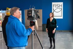Elizabeth Culbertson, FISH of Galesburg Executive Director, is interviewed by the media in their new home.