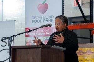 Caronina Grimble, director of the Office of Strategy, Equity, and Transformation at the Illinois Department of Human Services, addresses the crowd before the ribbon-cutting at the River Bend Food Bank, Galesburg Branch on November 15, 2022.