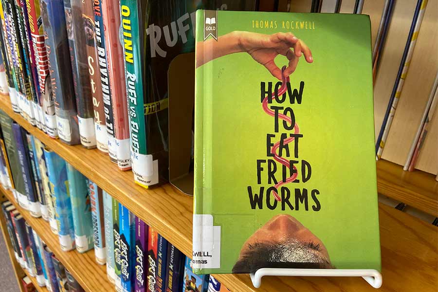 Bookshelf with "How to Eat Fried Worms" Book displayed