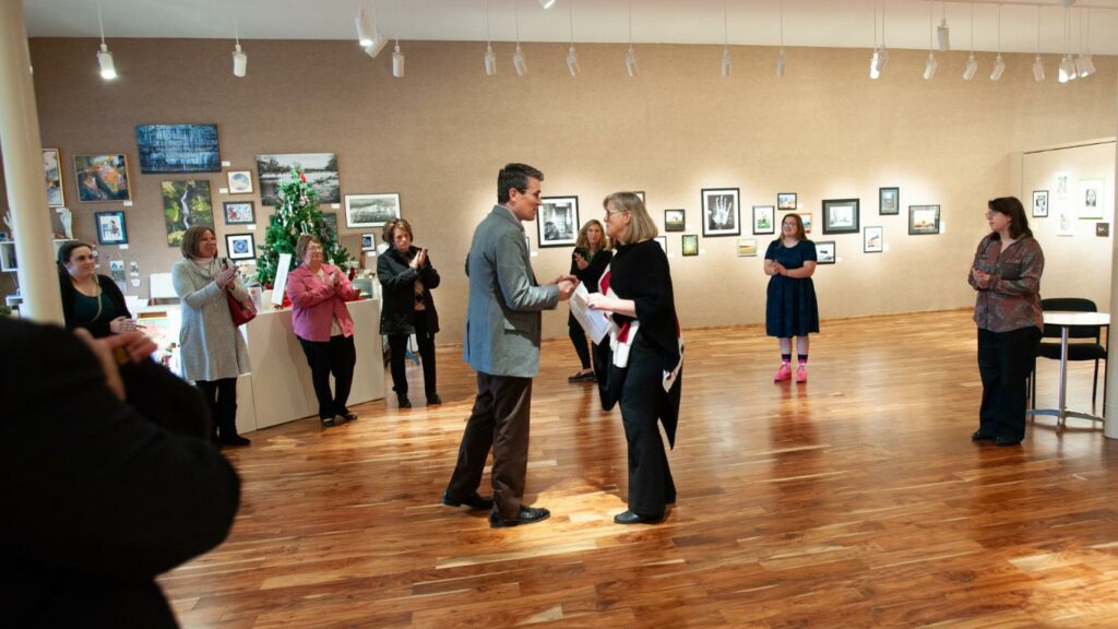 Joshua Gibb, President & CEO of Galesburg Community Foundation, presents a check to Kristyne Gilbert, Executive Director of Buchanan Center for the Arts, for their endowment.