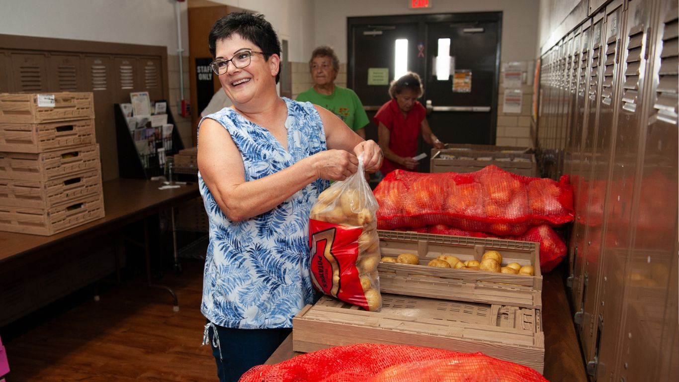 Volunteers unpack food received at Helping Hands of Roseville food pantry.