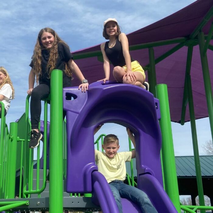 Children play on the playground equipment build and dedicated to Maci Mulvey.